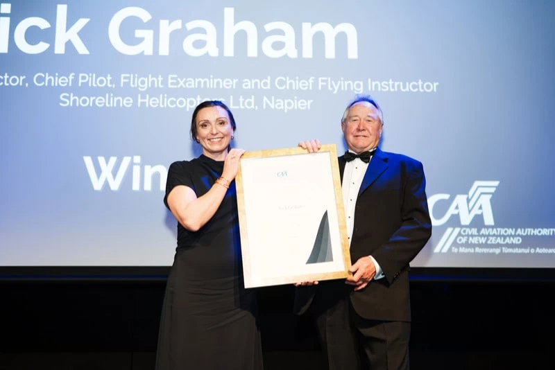 Acting Director of Civil Aviation, Catherine MacGowan, presents Rick Graham with the CAA’s Director’s Award for aviation safety